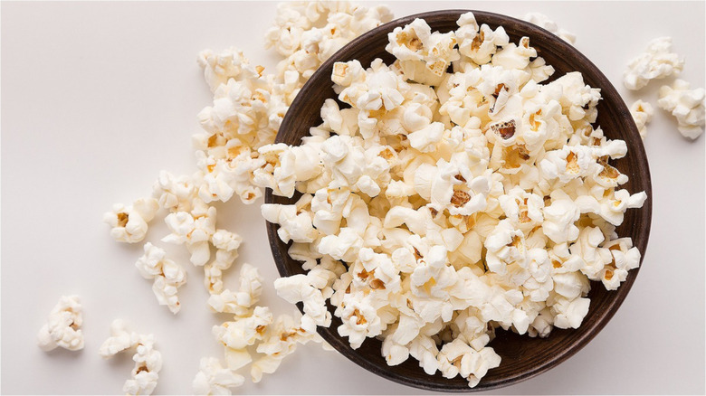 overhead view of spilled popcorn bowl