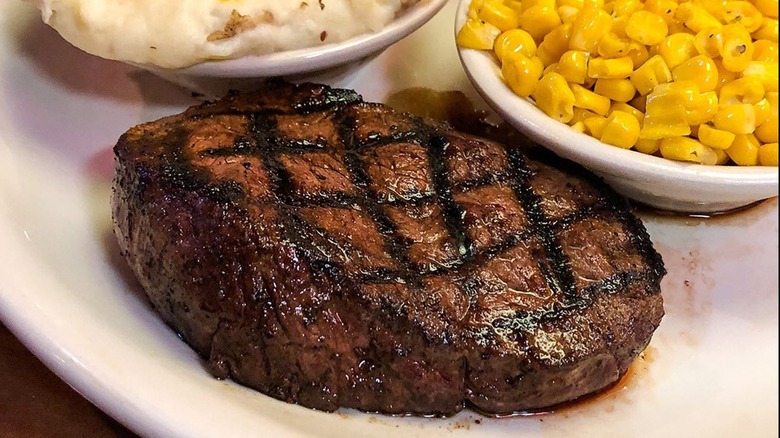 Texas Roadhouse steak, corn, and mashed potatoes on plate
