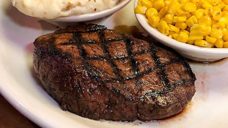 Texas Roadhouse steak, corn, and mashed potatoes on plate