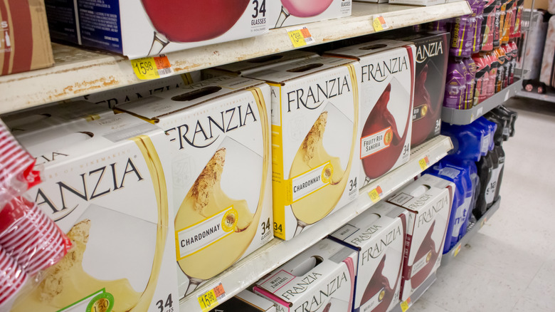 Assorted boxes of Franzia wine on grocery store shelf.
