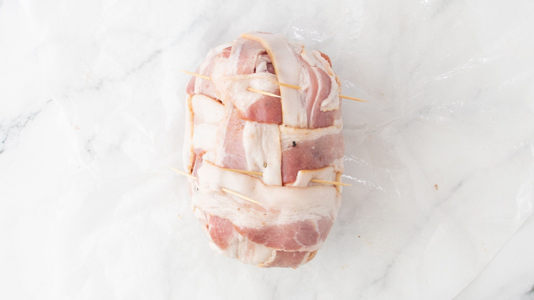 Bacon-wrapped pineapple with toothpicks