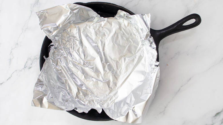 Sheet of aluminum foil pressed into cast iron skillet