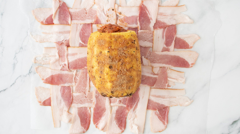 Whole pineapple on top of woven bacon strips