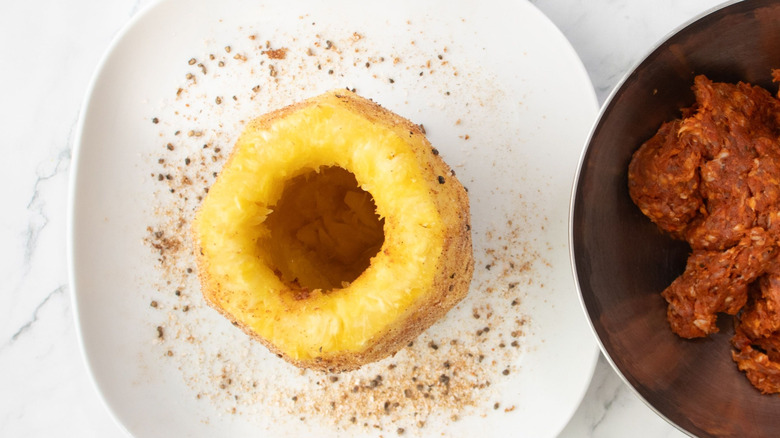 Cored and peeled whole pineapple on plate
