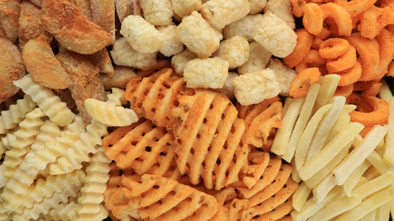 Close-up of various frozen french fry types.