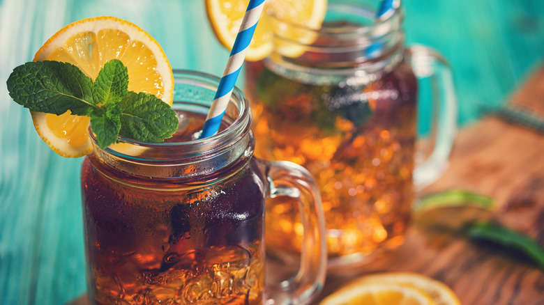 Two jar mugs of sweet tea, mint, and lemon