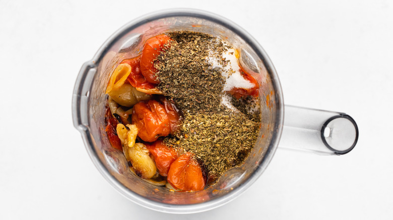 Roasted tomatoes, onion, and seasonings in blender jug