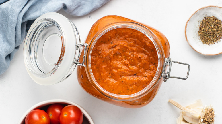 Top down view of marinara sauce in glass jar