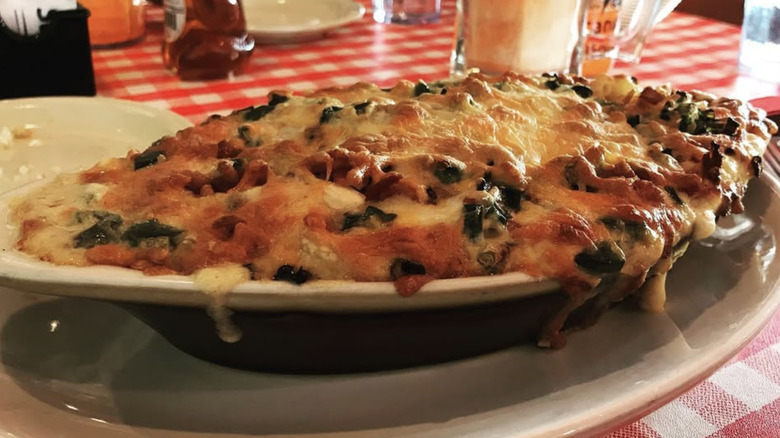 Baked mac and cheese on red and white tablecloth