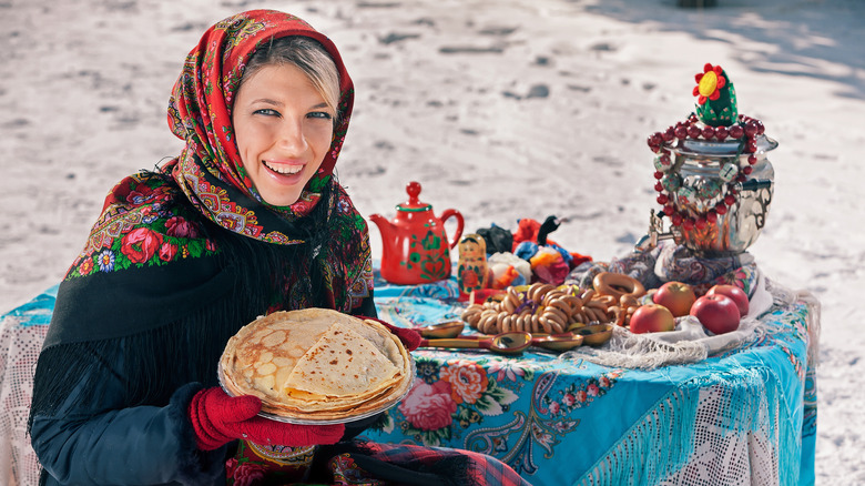 woman celebrating Maslenitsa festival with pancakes