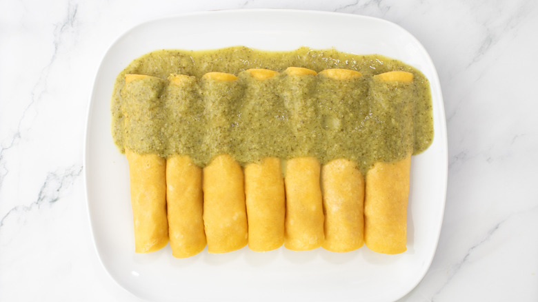 rolled tortillas topped with green sauce