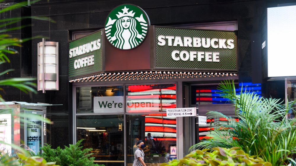 person walking outside of a Starbucks in NYC