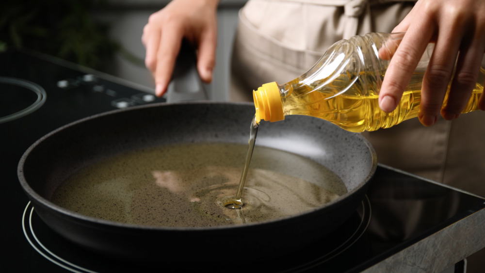 Pouring oil into pan