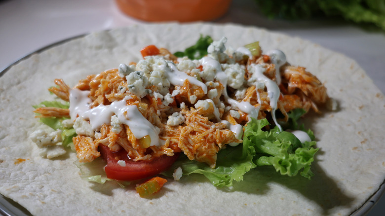flour tortilla topped with lettuce, tomato, shredded Buffalo chicken, blue cheese, and ranch dressing
