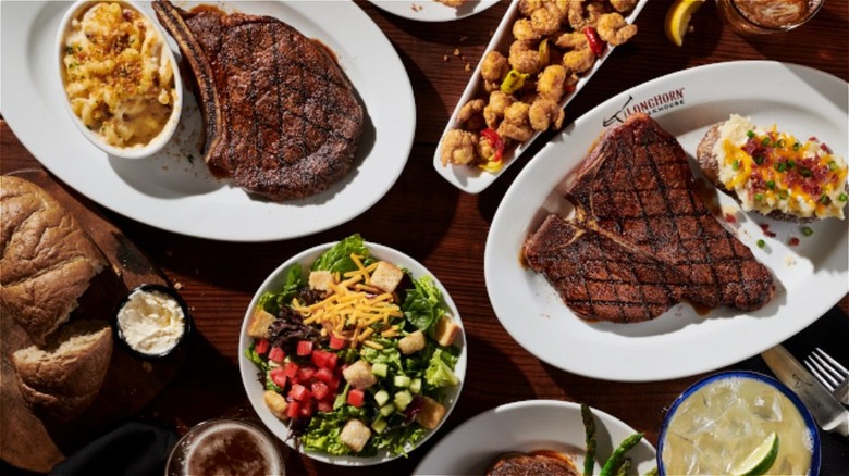 Steaks, shrimp, parmesan-topped mac and cheese, and baked potato at LongHorn Steakhouse