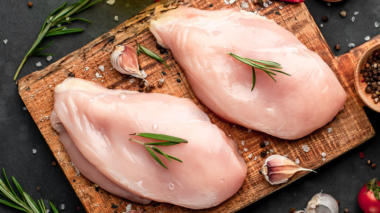 Two chicken breasts on cutting board