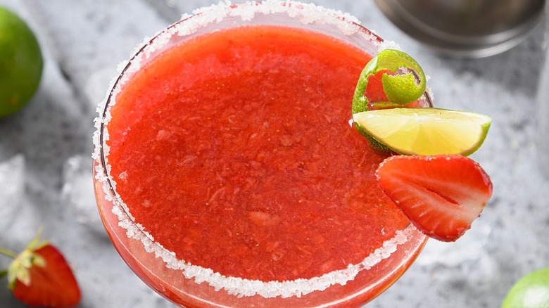 A blended strawberry margarita with salt on the rim