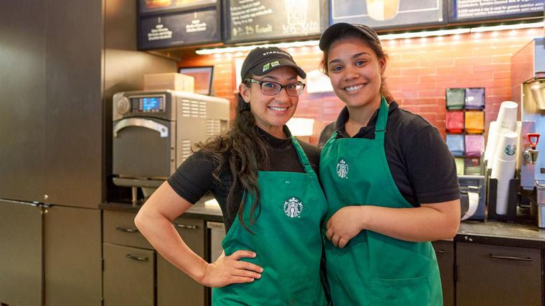 Starbucks baristas in green aprons