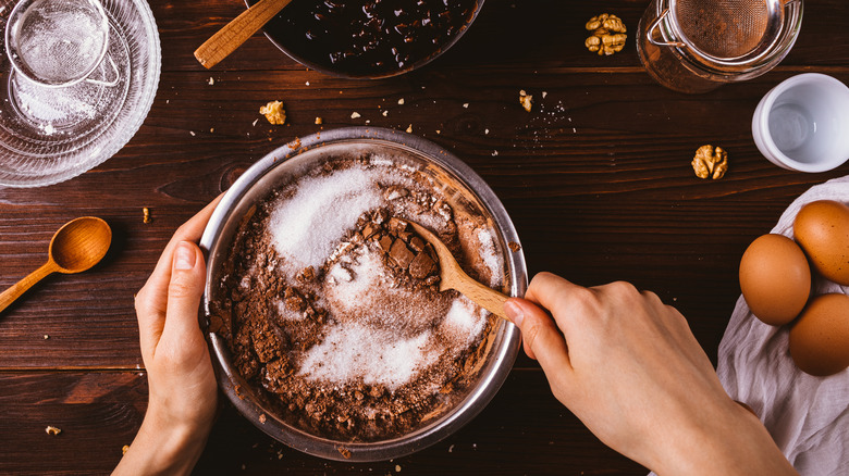 Person making a chocolate cake