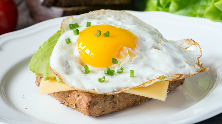 Sunny-side up egg on toast with cheese