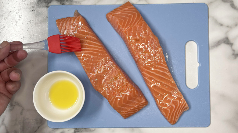 brushing oil on salmon filets