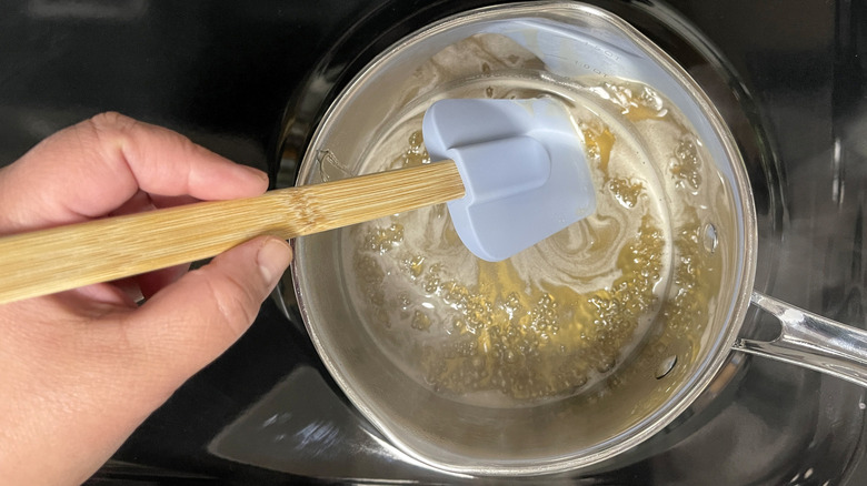 stirring honey, butter, and bourbon in saucepan