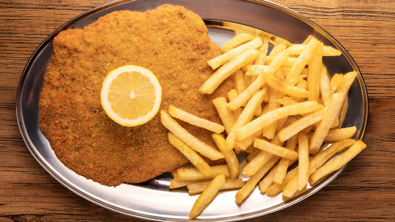 Milanesa napolitana on a plate with fries
