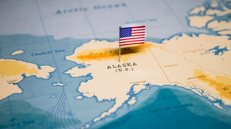 US flag in Alaska on map