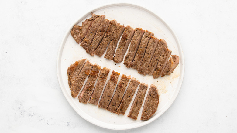 Two sliced sirloin steaks on a plate