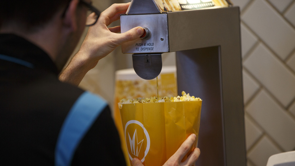 Person buttering popcorn