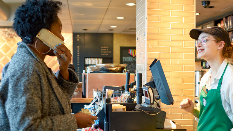 Customer paying Starbucks Cashier
