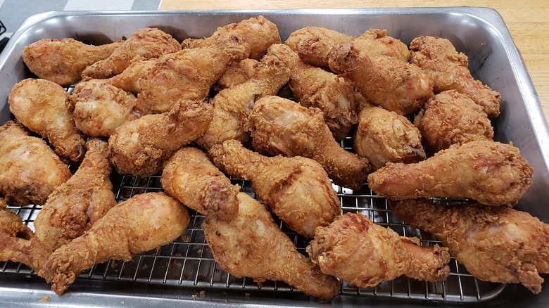 Fried chicken drumsticks on wire rack