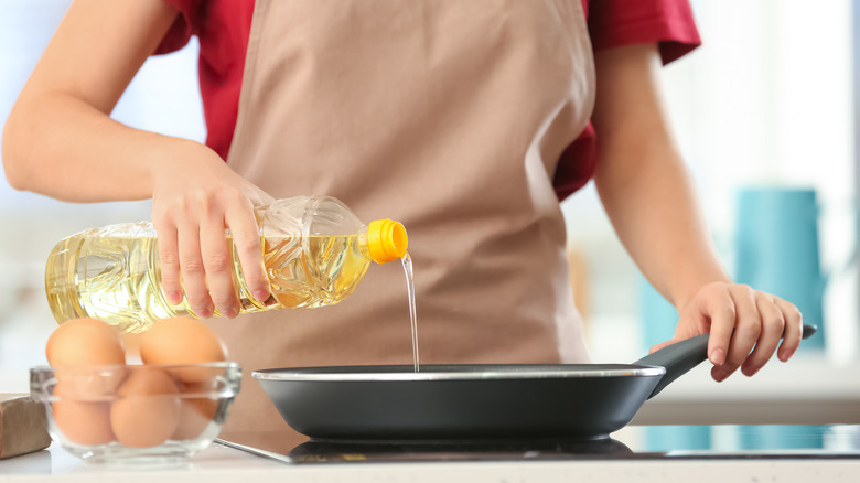 Person pouring oil