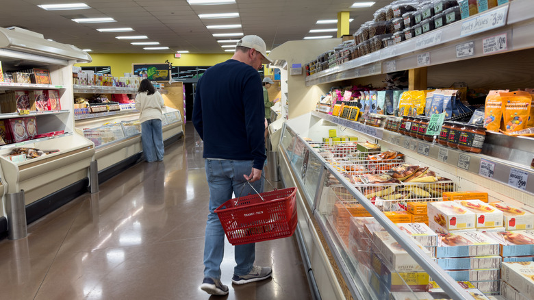 Customer shopping frozen food aisle of Trader Joe's