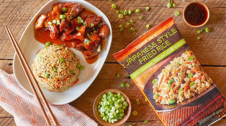 Trader Joe's Japanese-style fried rice bag next to fried rice & meat plate and bowl of chopped scallions