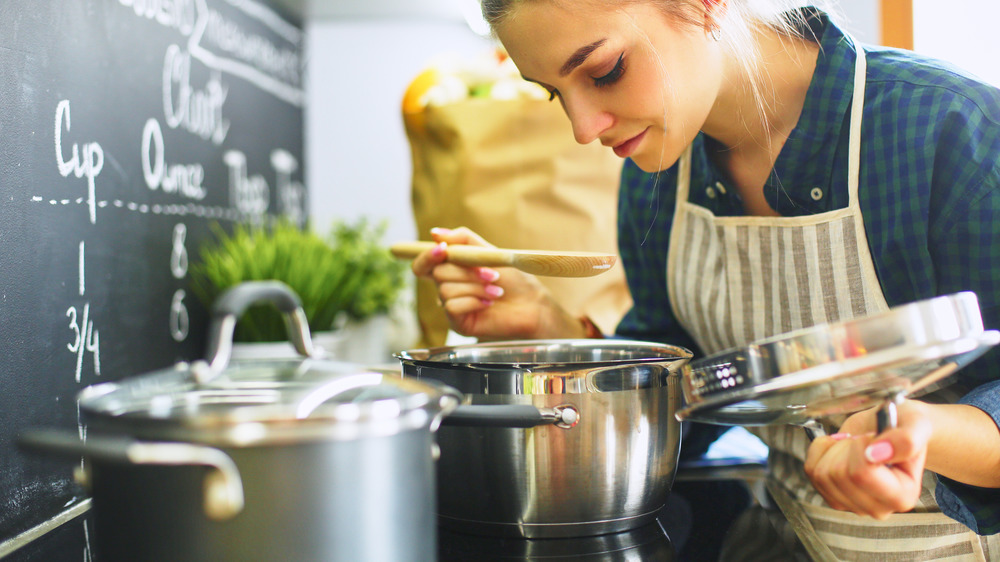 Young woman looking into pot