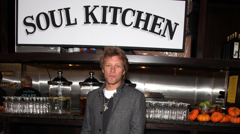 Jon Bon Jovi standing in front of the Soul Kitchen sign, at the opening of the Red Bank property.