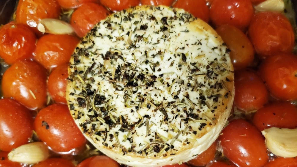 Feta, tomatoes, and garlic in baking dish