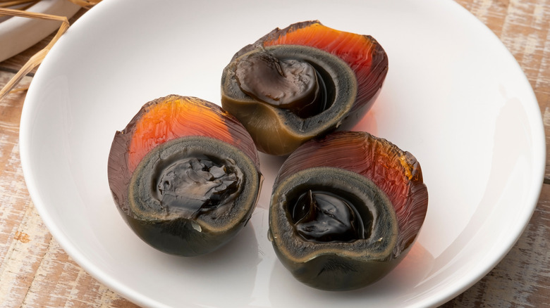 Sliced century duck eggs on white plate