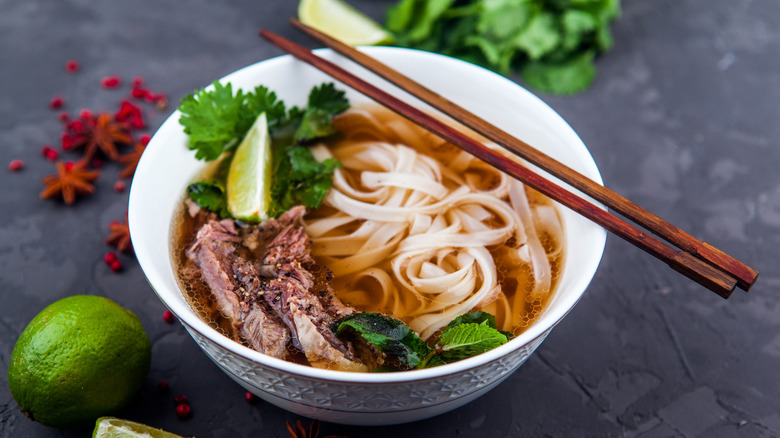 Bowl of beef pho with chopsticks