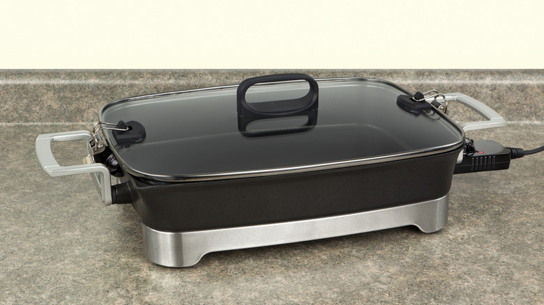Electric skillet on a kitchen countertop.