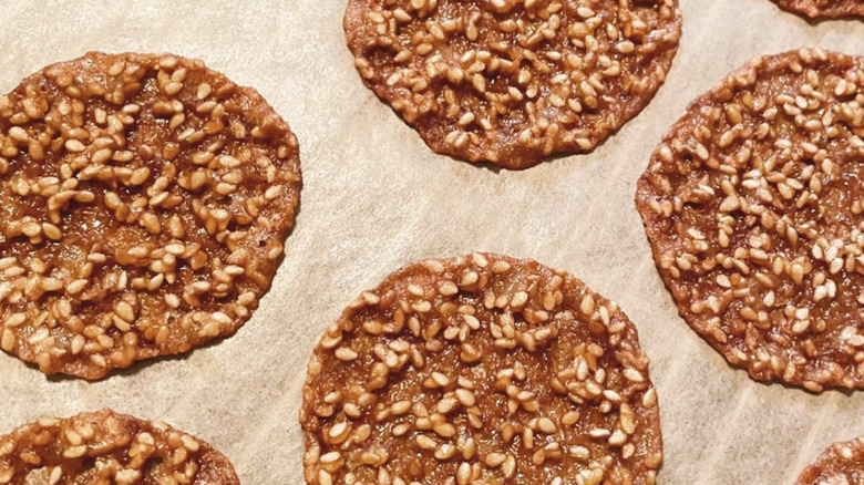 Rows of benne wafers on parchment paper