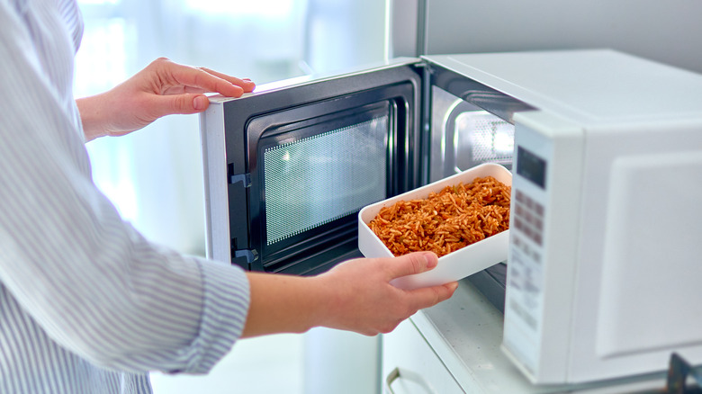 Putting container of food in microwave