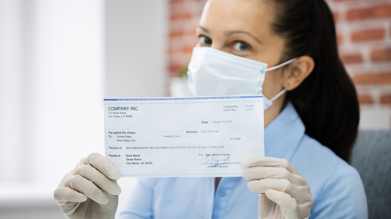 Woman holding paycheck