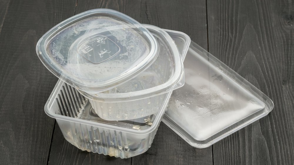 plastic food containers against a wooden background