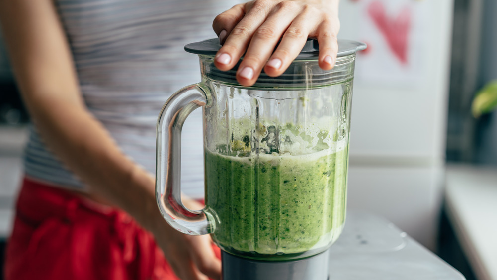 person using a blender