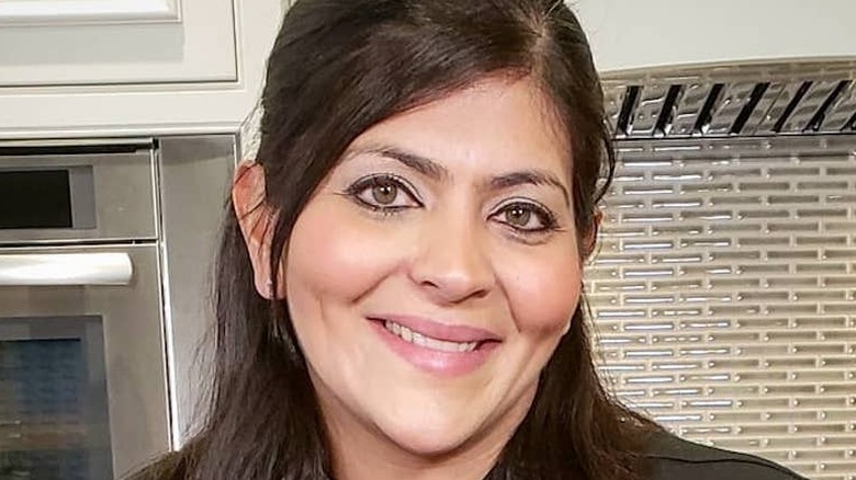 Saba Wahid smiling in her kitchen