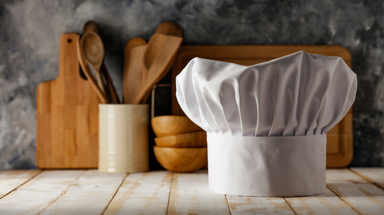 Chef hat with wooden utensils 