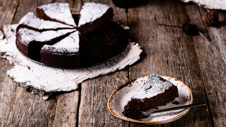 Sliced chocolate cake with powdered sugar on top