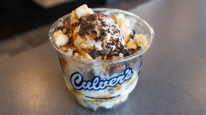 Cup of Culver's frozen custard with toppings on countertop.